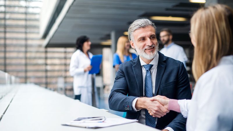 Medical device distribution strategy meeting between a company executive and a hospital clinician