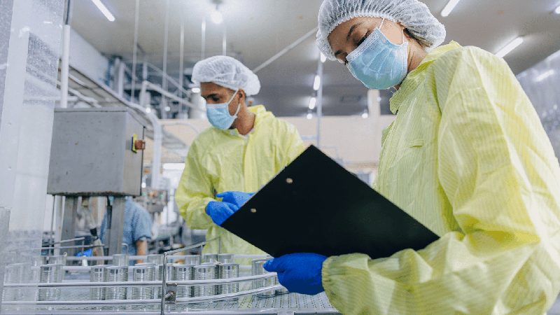 Quality engineers inspecting medical device manufacturing on the production line