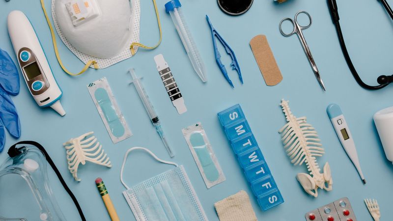 Medical devices and clinical supplies arranged on a blue surface