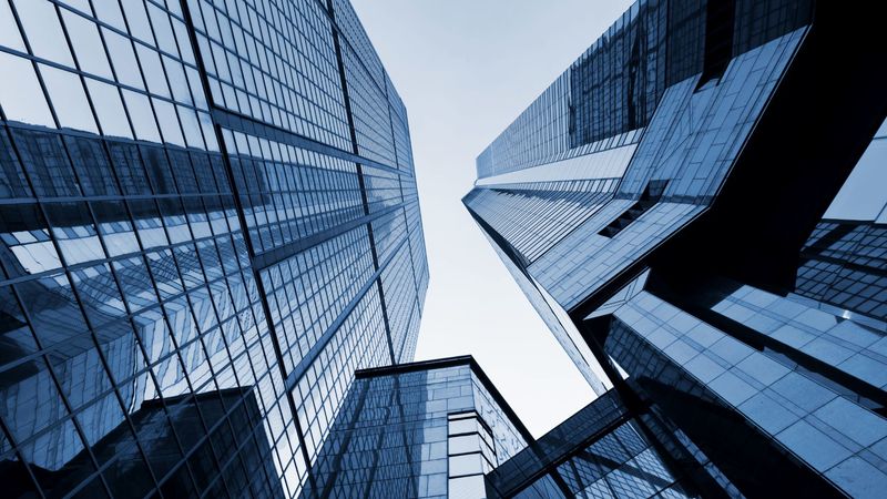 Glass office towers viewed from below, representing MedTech revenue operations as launch infrastructure